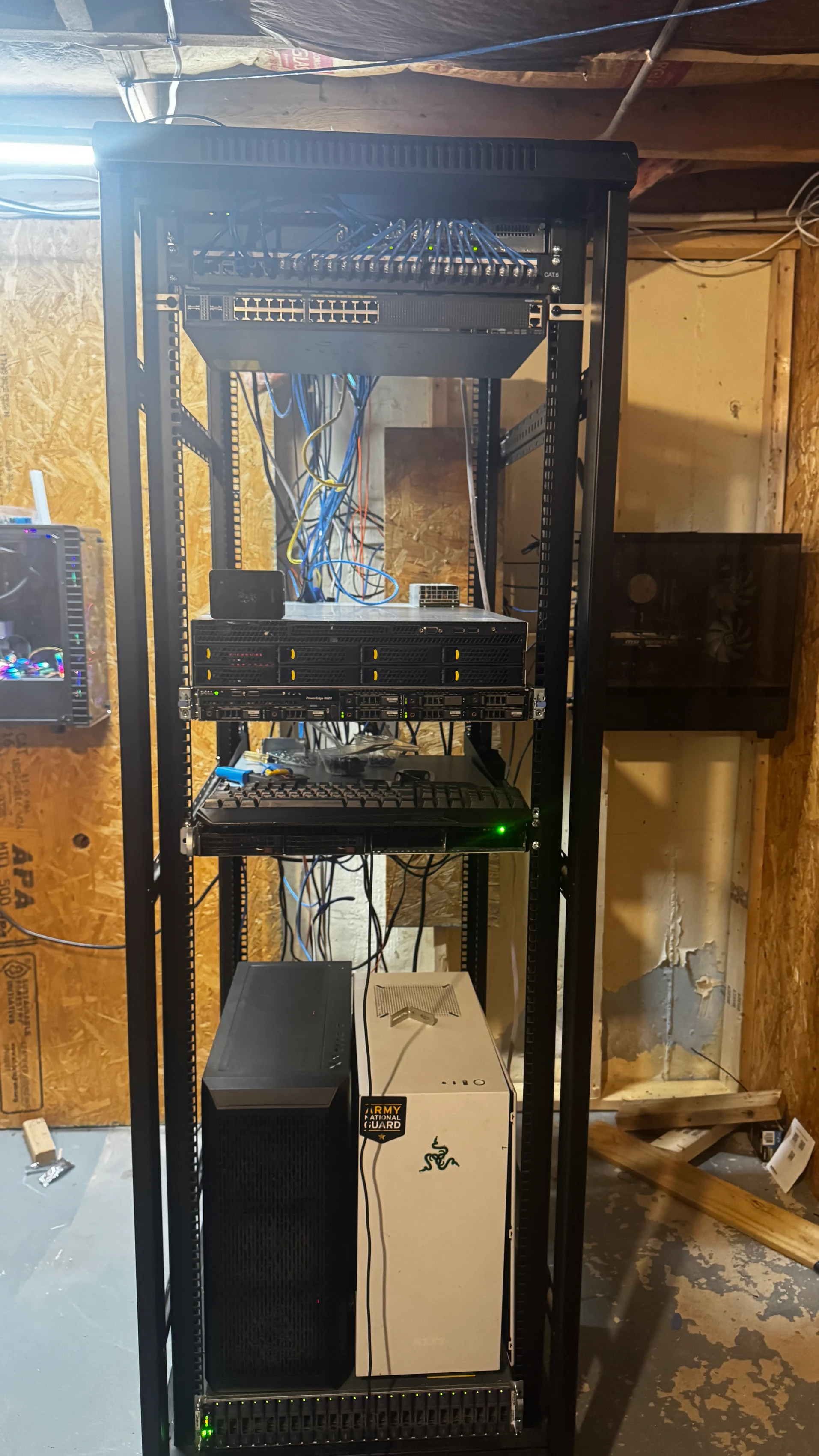 Current full server rack with CAT6 patch panel, Cisco switch, rack servers, black TrueNAS tower, white backup PC and bottom JBOD